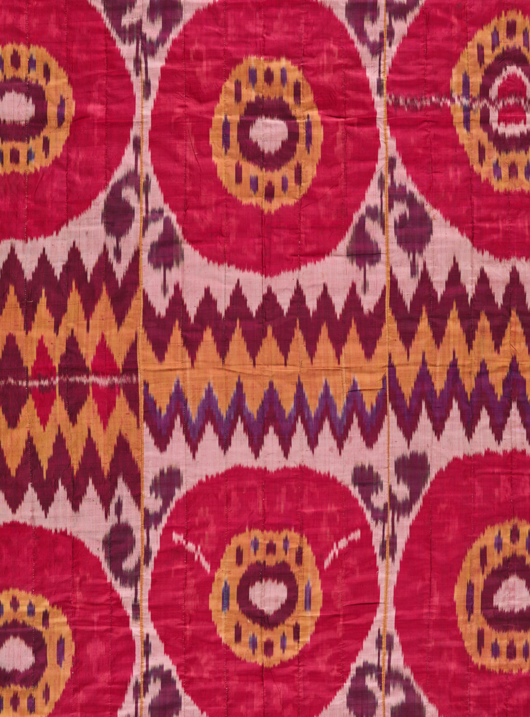 Bright ikat fabric with patterns of pink and yellow rings