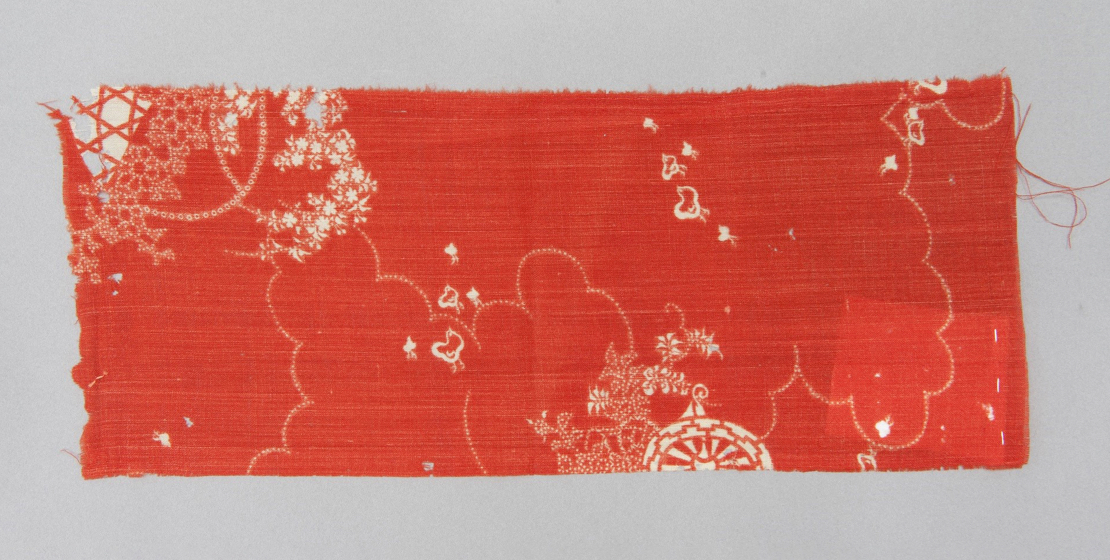 Coral-colored rectangular textile fragment
