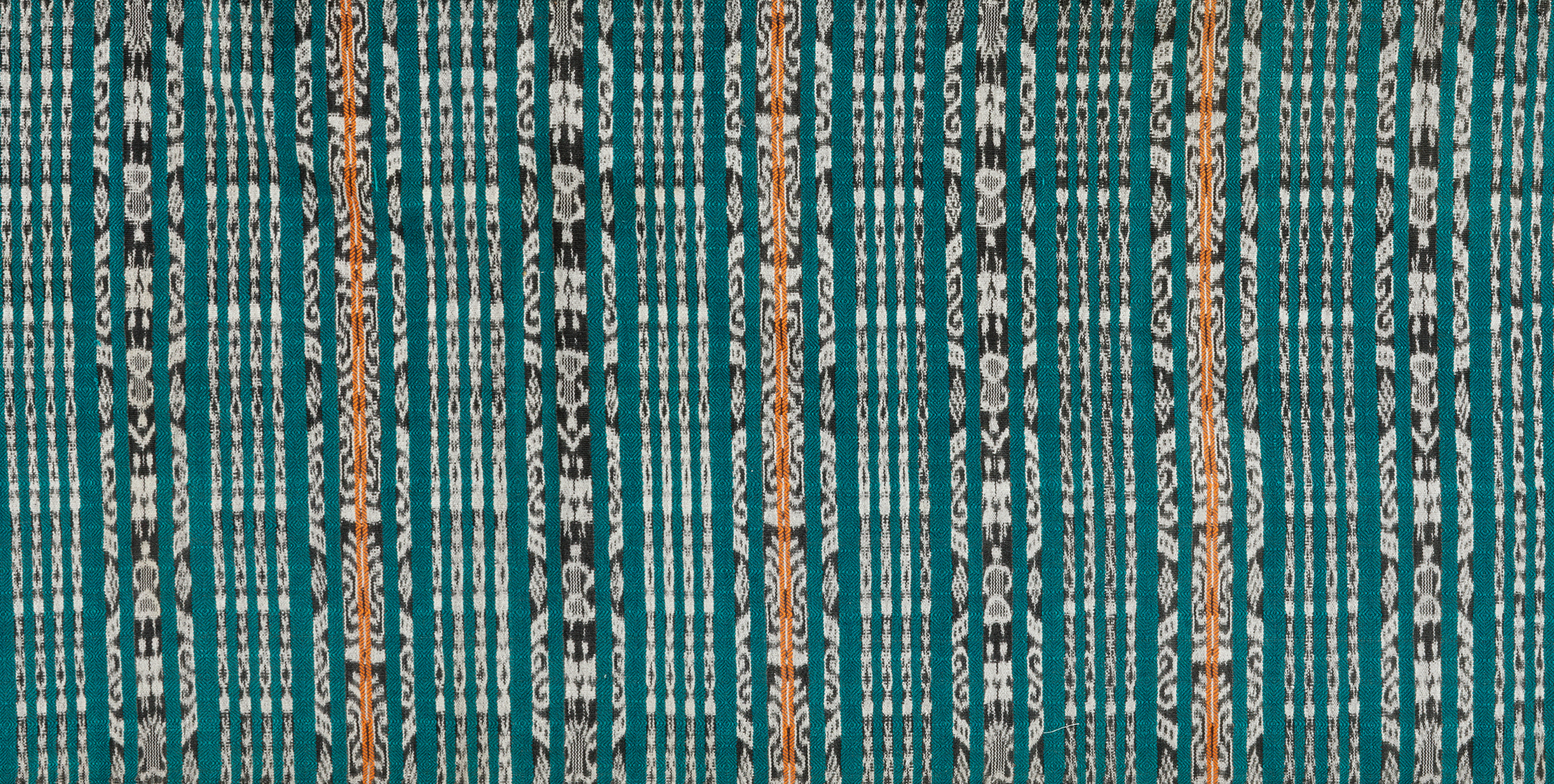 Teal-colored ikat textile with vertical stripes