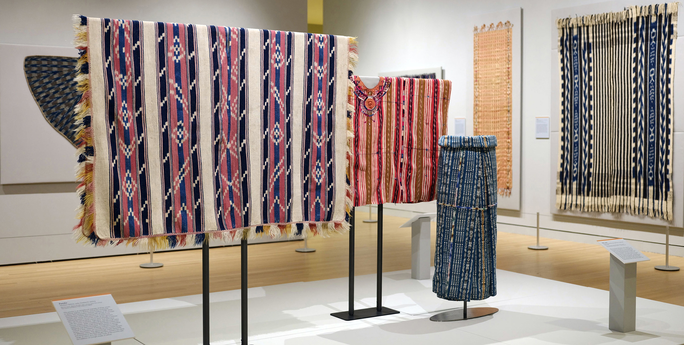 A display of colorful ikat textiles from the Americas