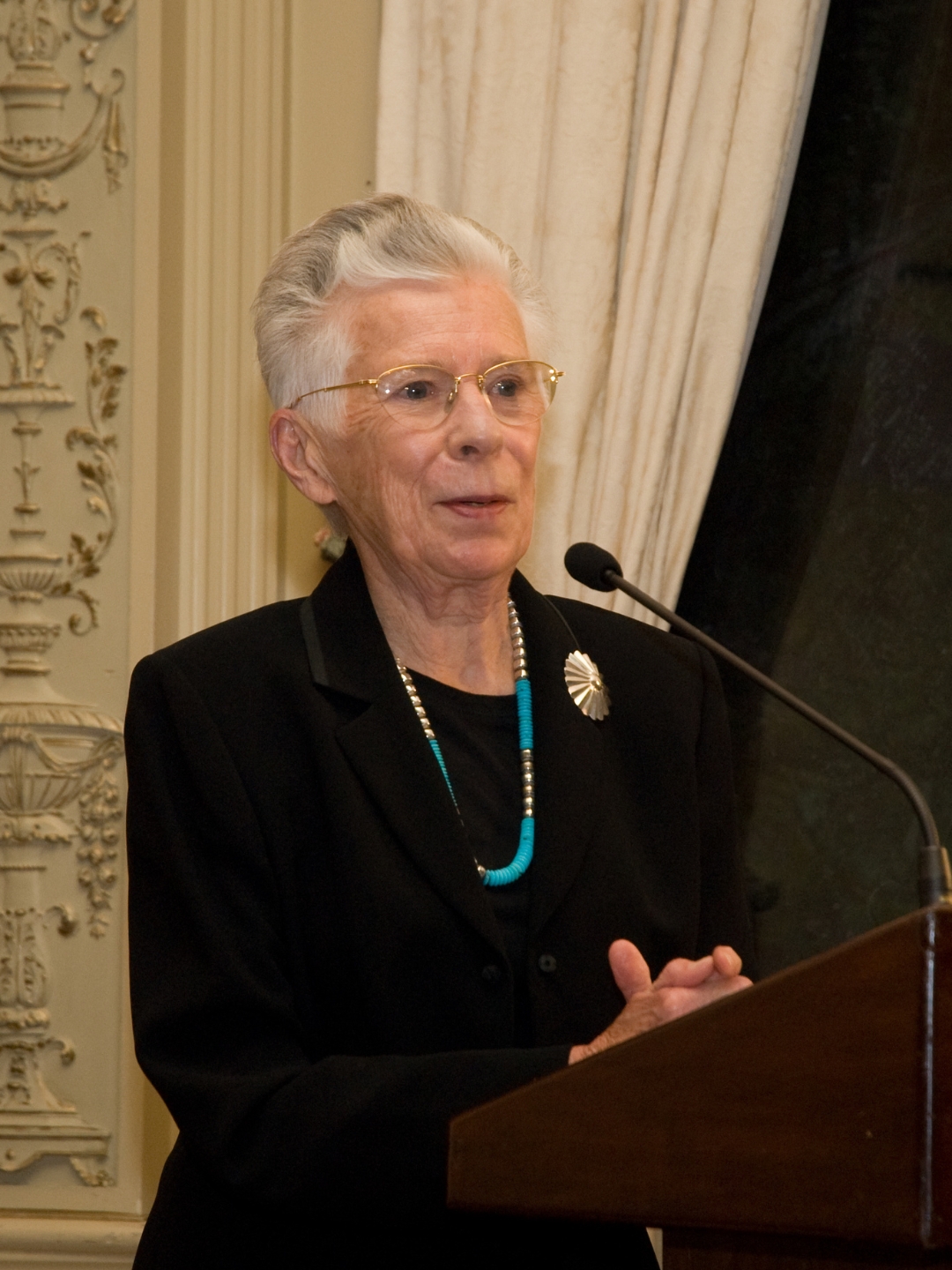 Dr. Mattiebelle Gittinger speaks from a podium