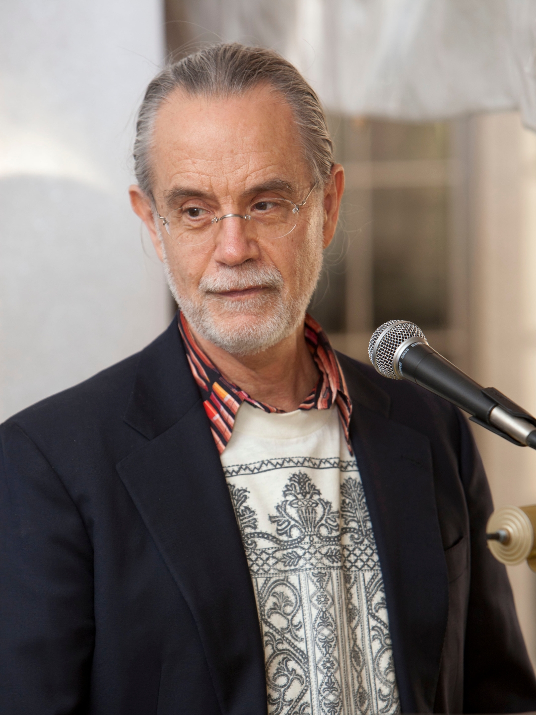 Milton Sunday, standing in a front of a microphone