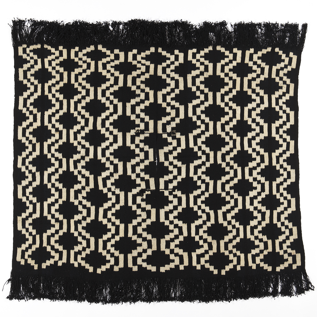 Square poncho in a deep navy color with white patterning