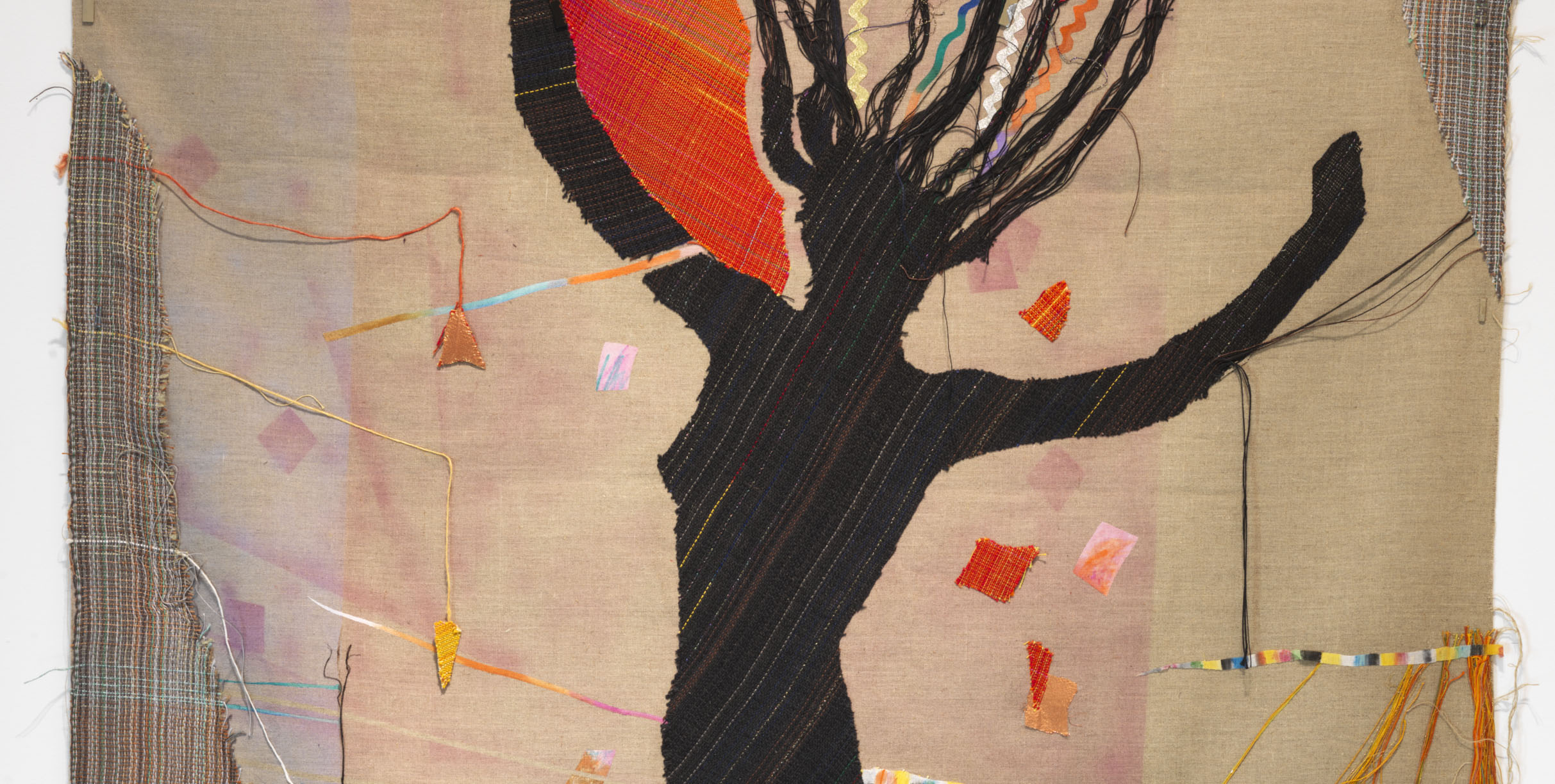 textile embroidered with the black silhouette of a woman leaping