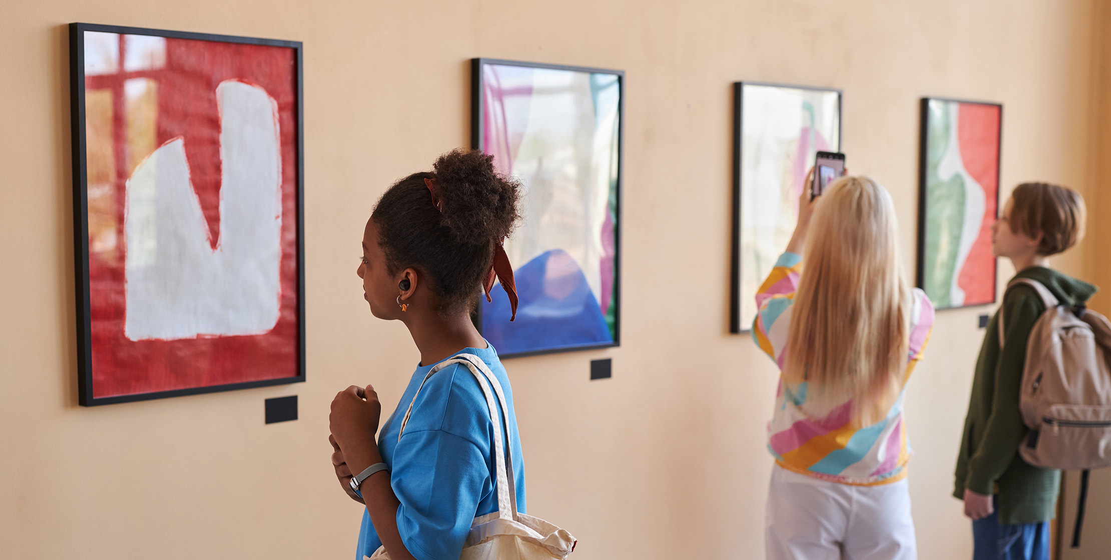 diverse group of students looking at art 