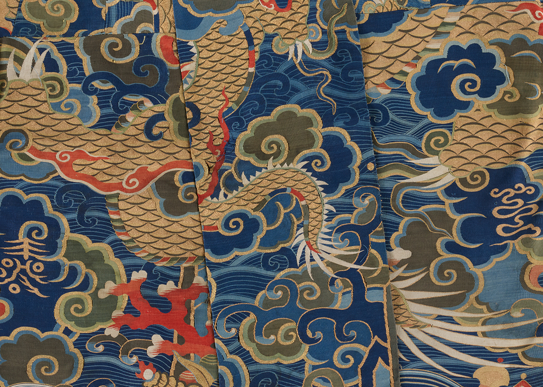 blue textile with dragon and cloud designs