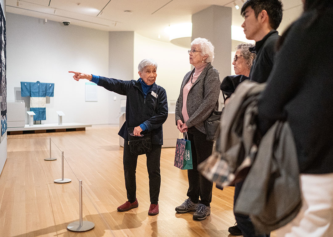 Woman giving a tour in a gallery