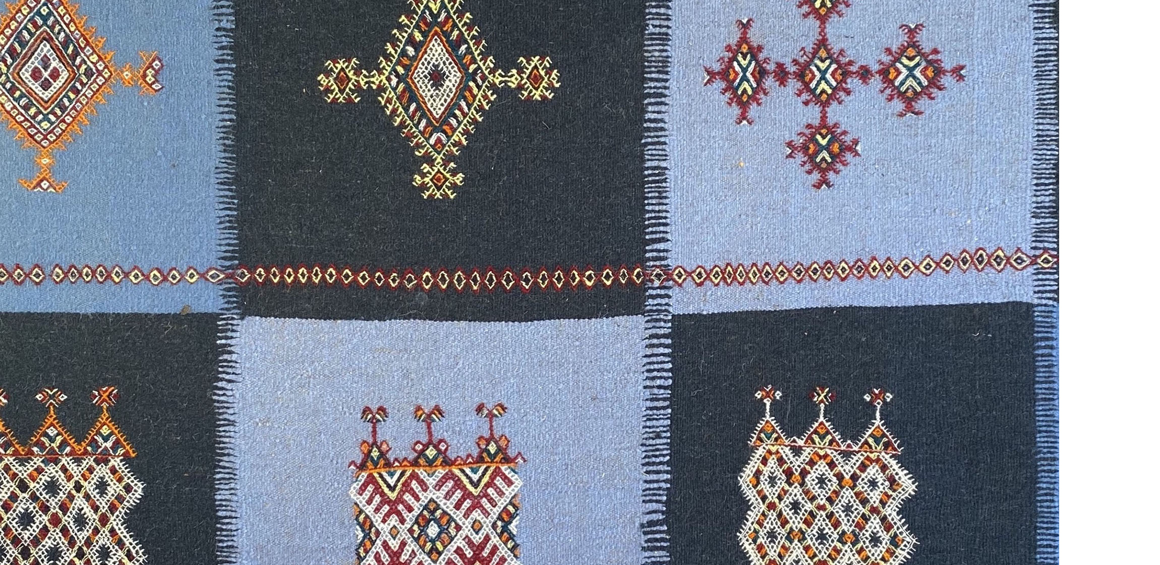 light and dark blue checkerboard textile with embroidery
