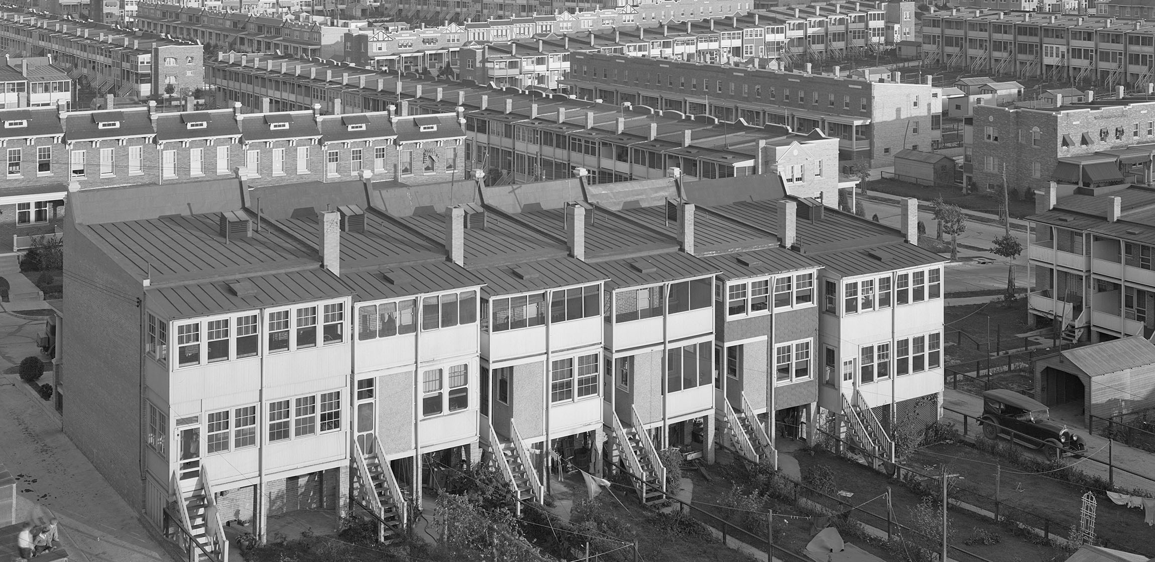 black and white photograph of neighborhood with row houses 