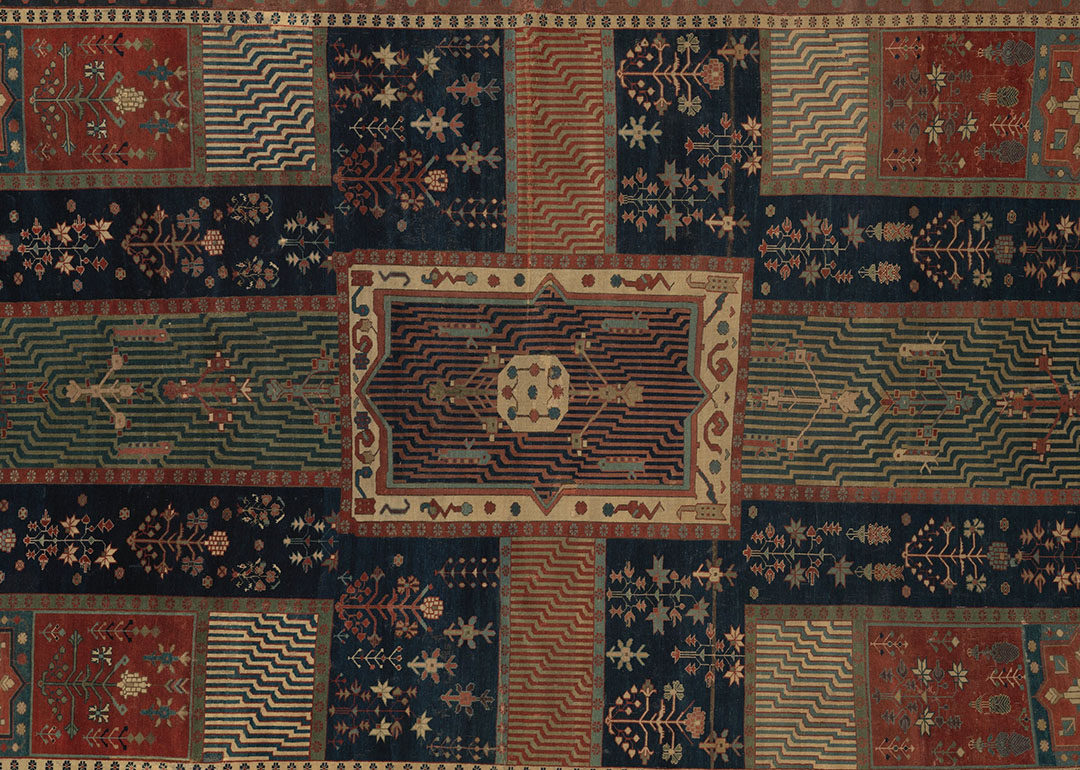 brown and green textile with central cross design