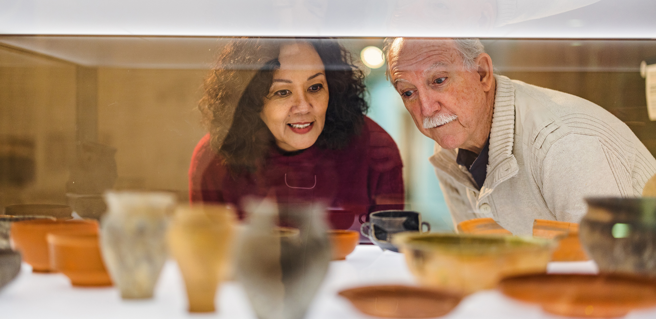 two people looking in a display case 
