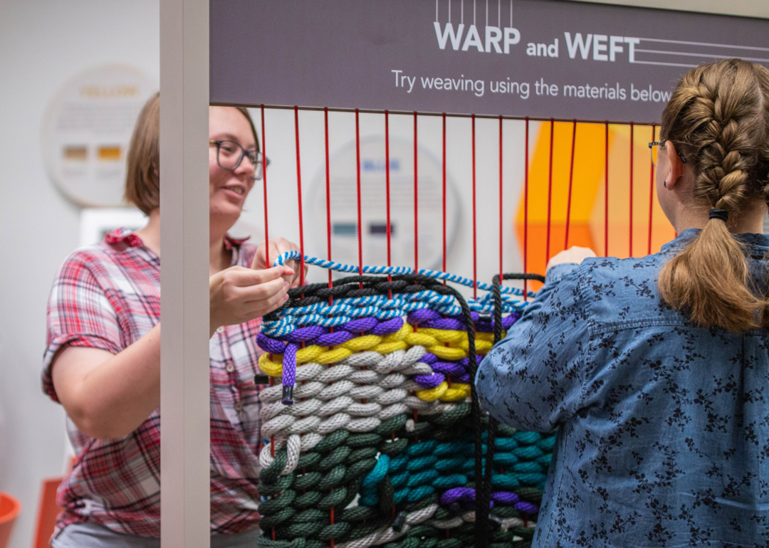 woman weaving on a large loom