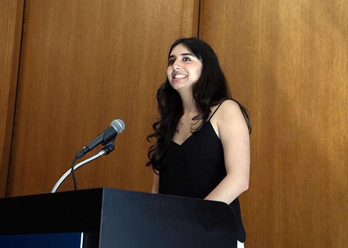 woman standing behind a black podium