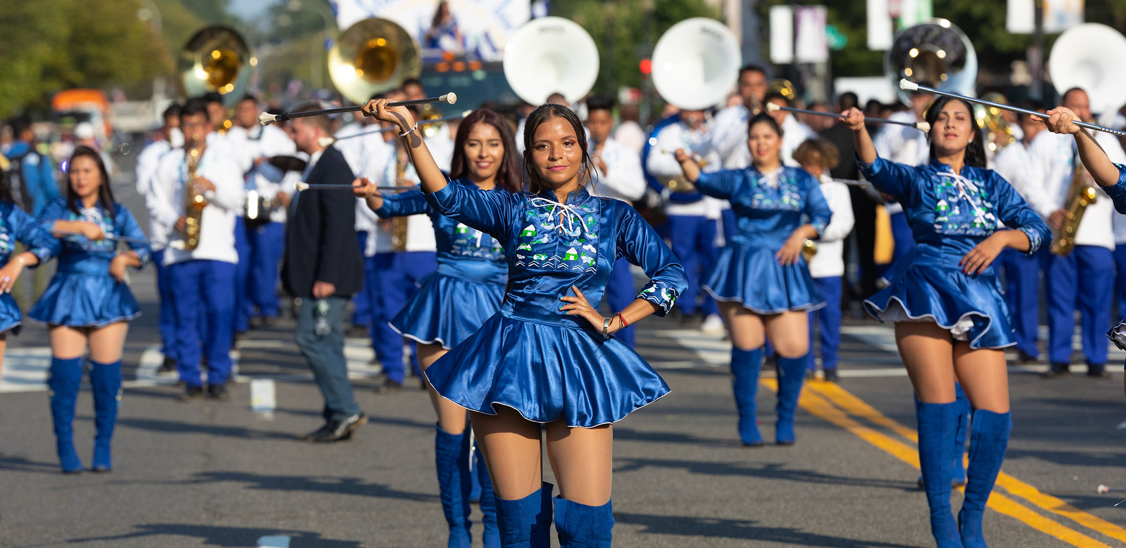 women parading in blue cheerleading outfits 