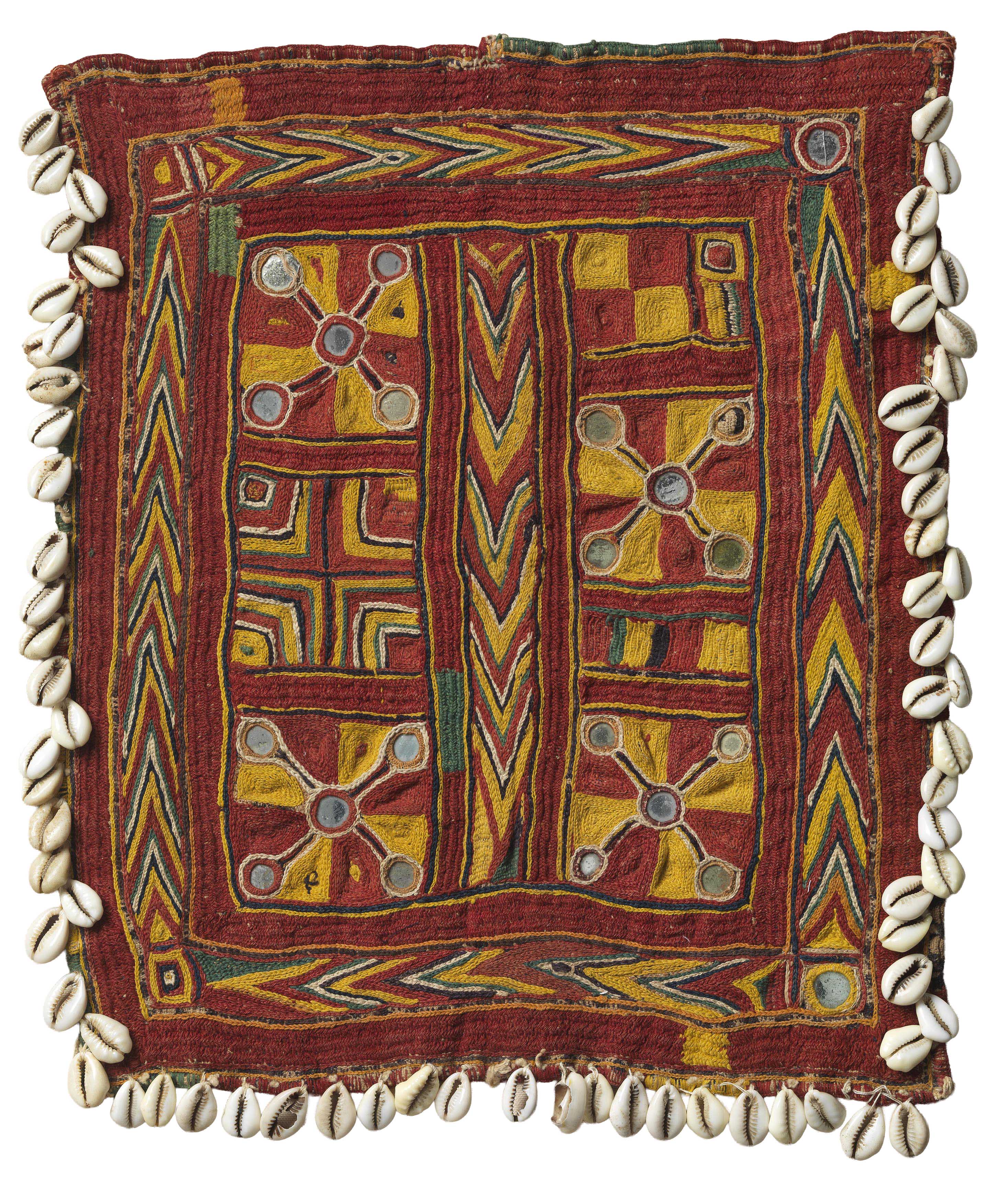 A woman wearing white gloves examines a textile fragment