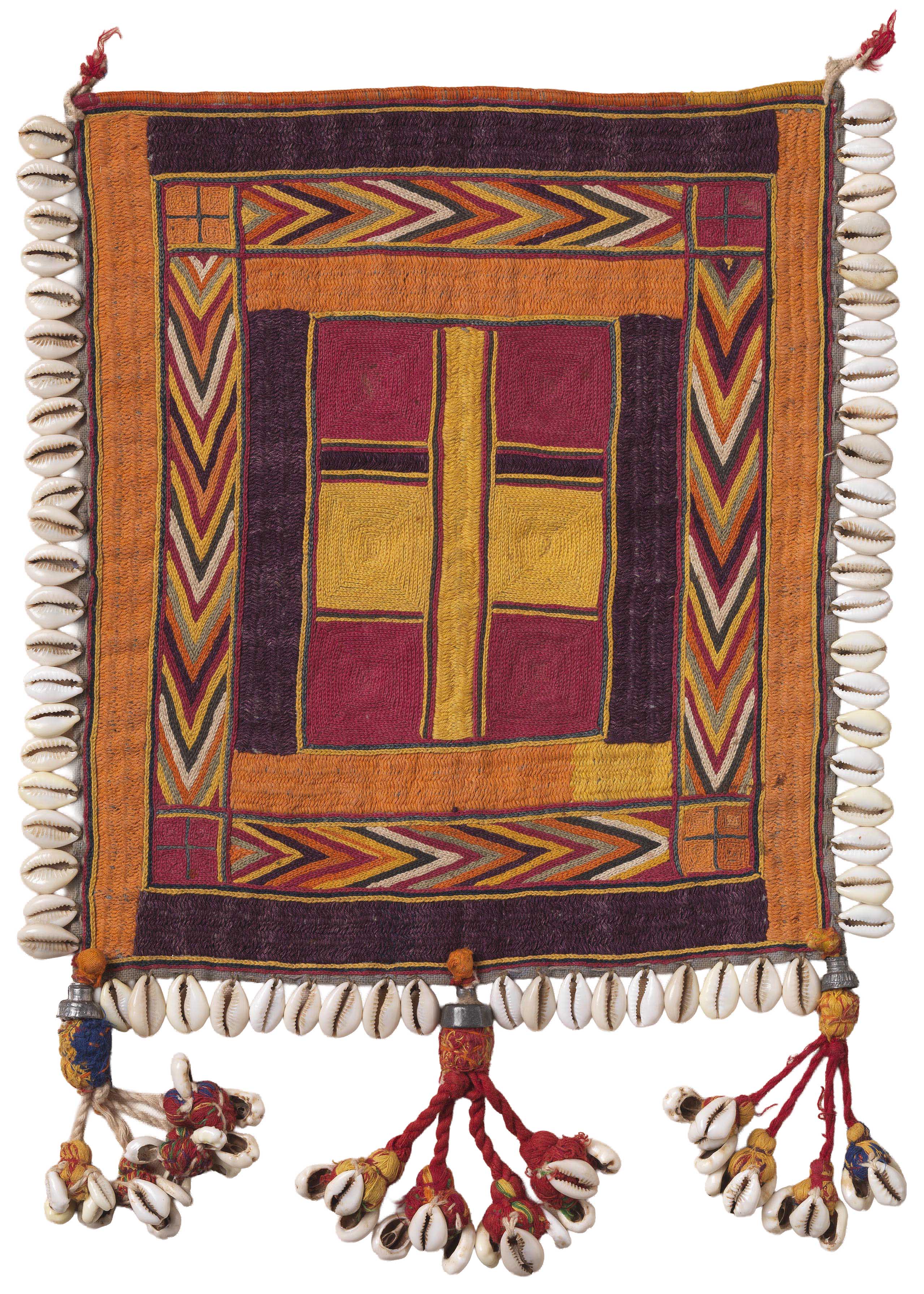 A woman wearing white gloves examines a textile fragment