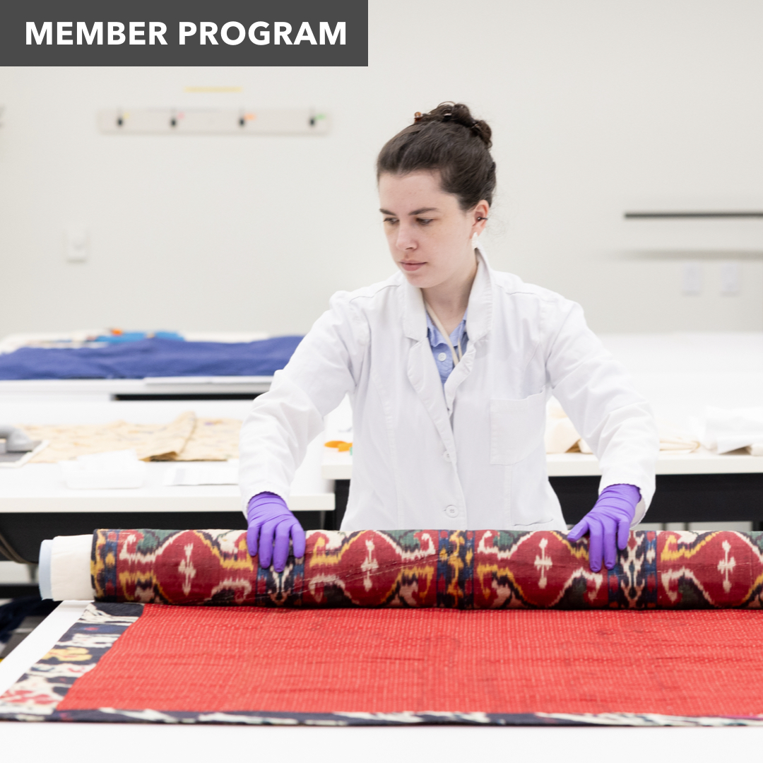 a woman unfurls a large carpet