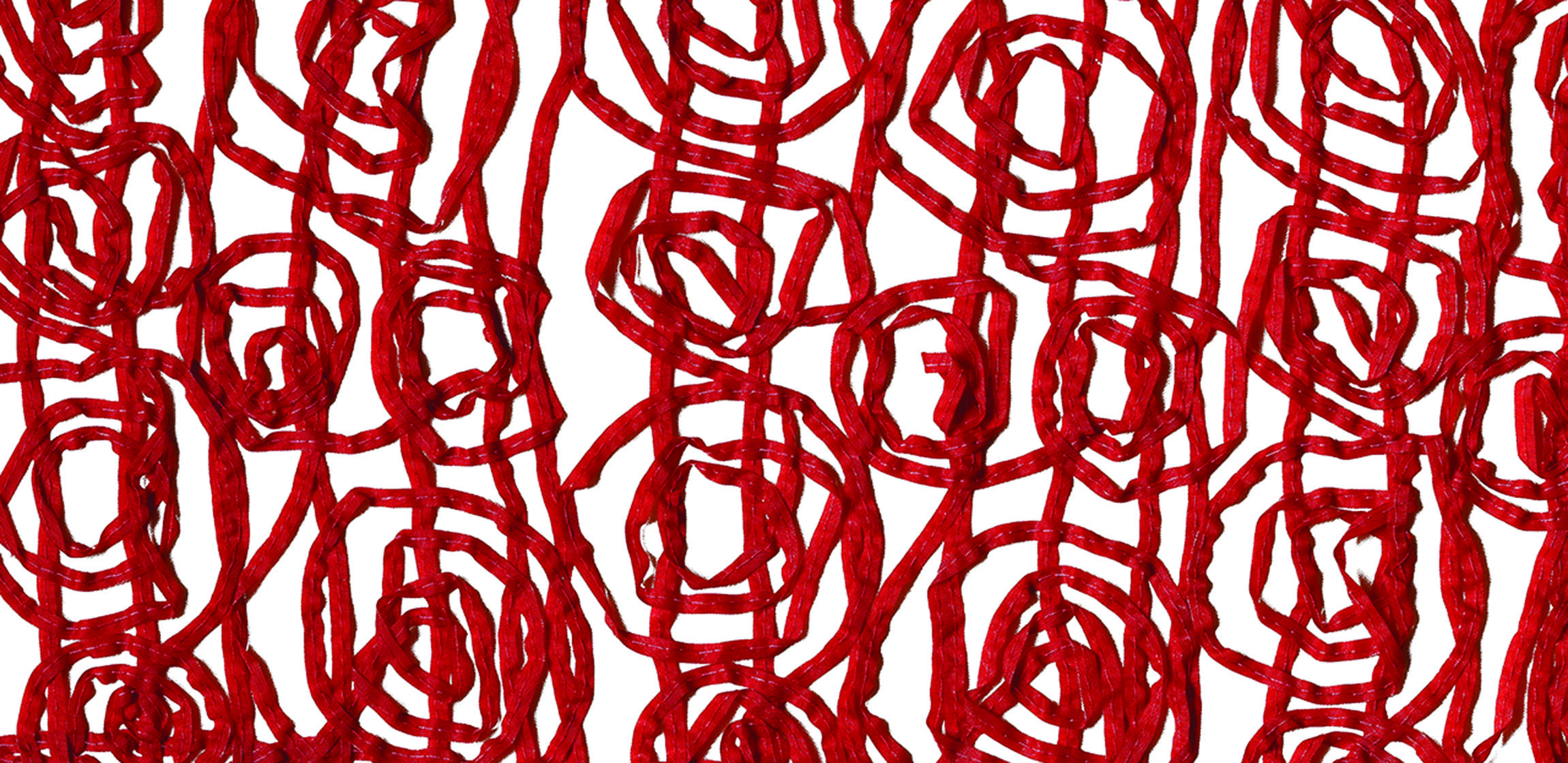 red yarn laid against a white surface