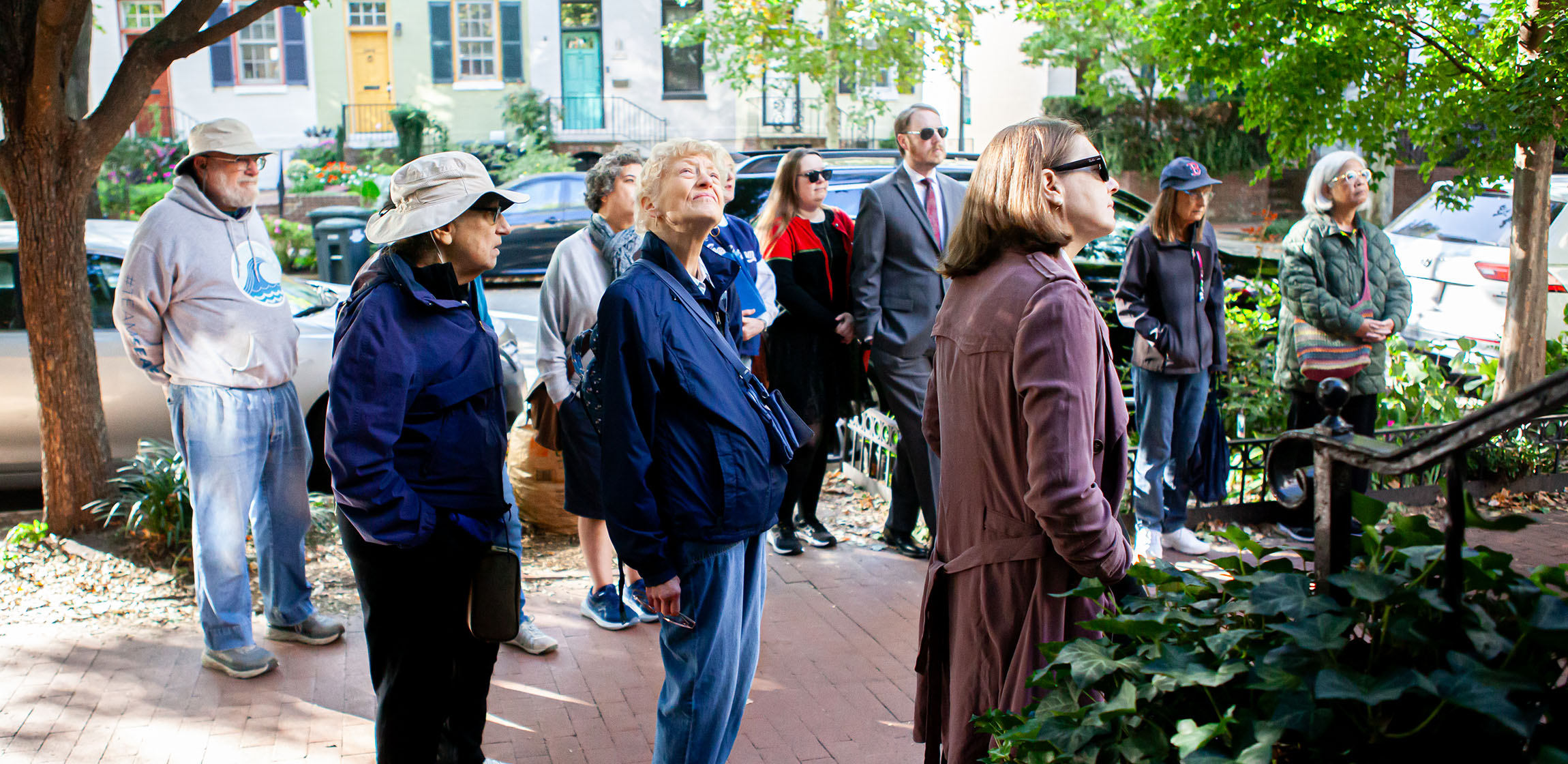 a group of people on a walking tour of a nieghborhood