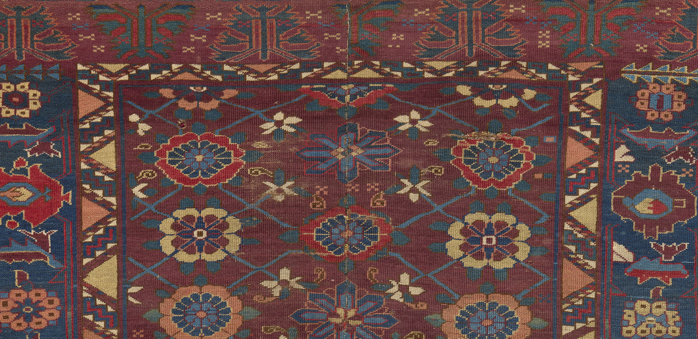 Carpet with dark red ground and small floral medallion motifs