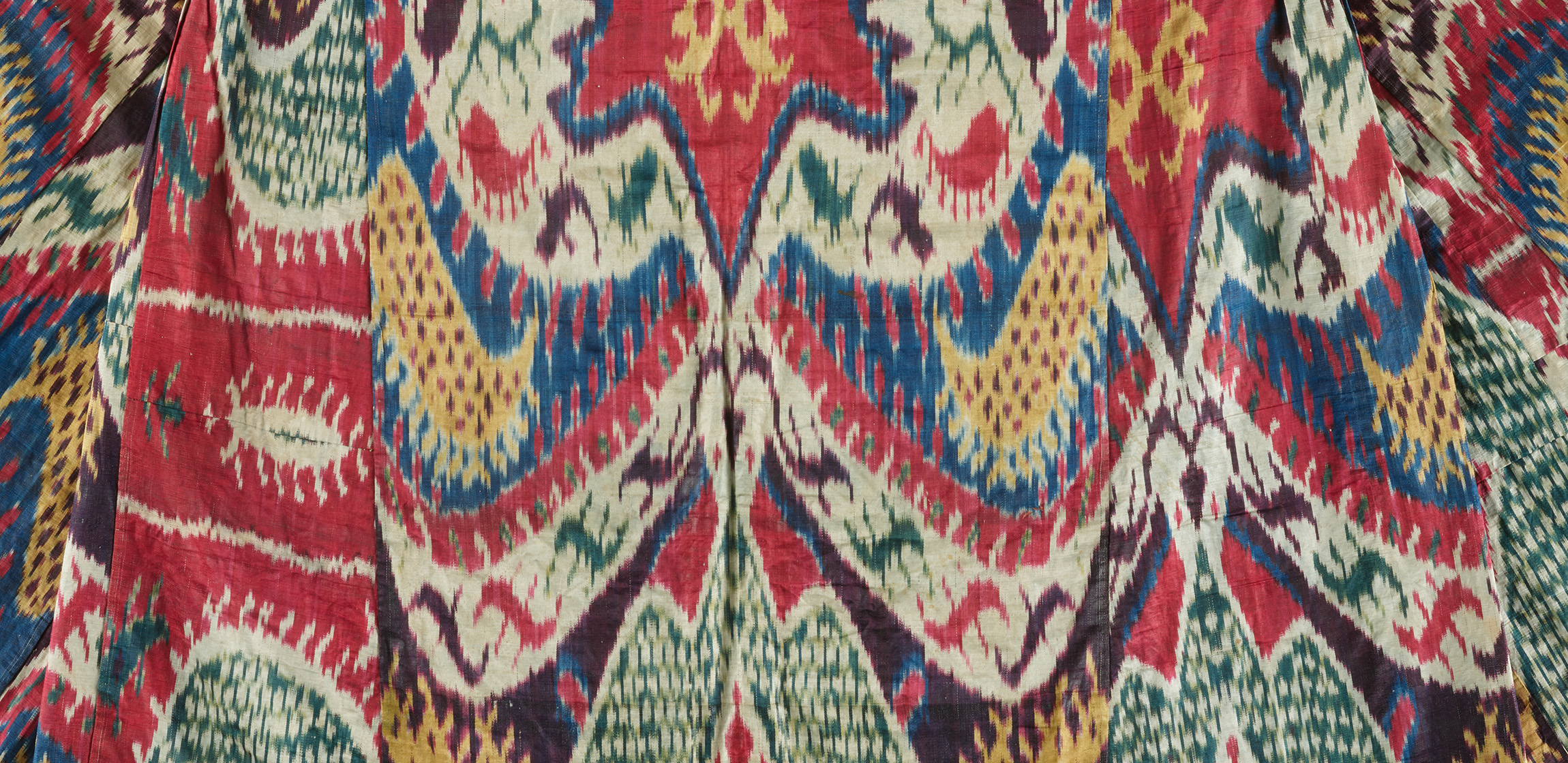brightly colored ikat robe in shades of red, blue, green, and yellow