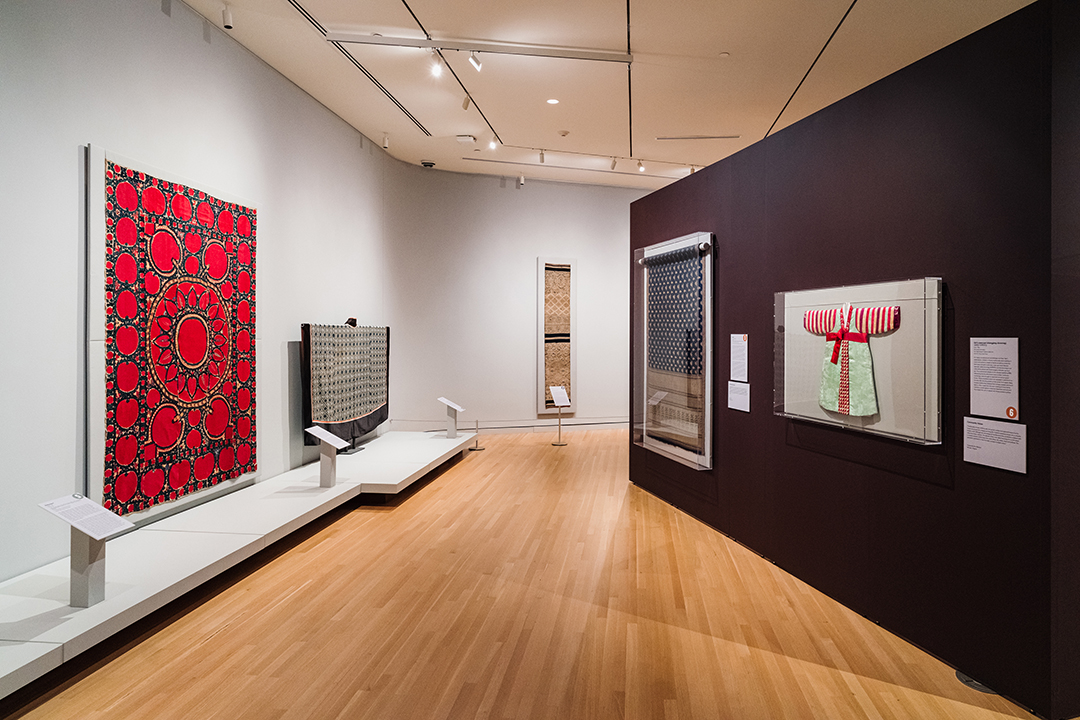 open gallery space showing textiles on the wall