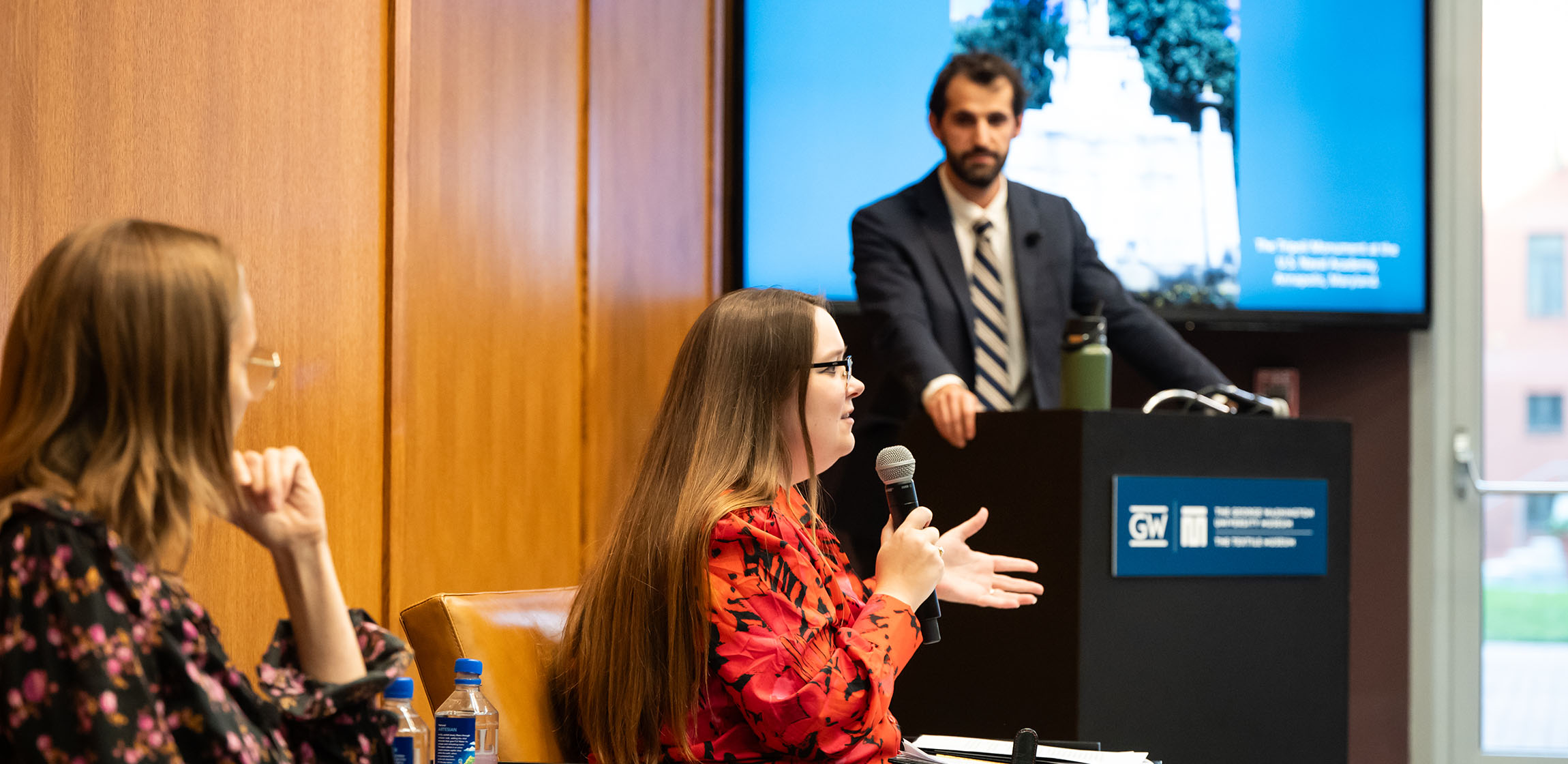 a panel speaks to a room of attendees