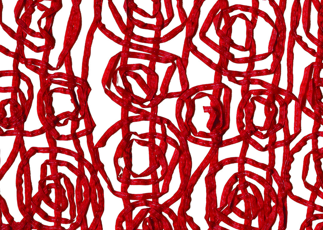 red fibers viewed against a white surface