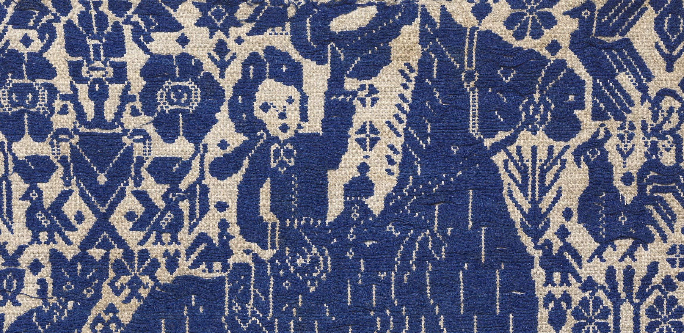 blue embroidery of a horse and its rider