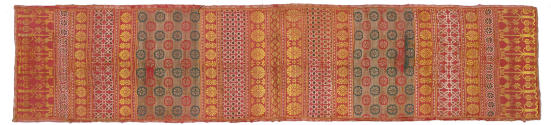 Long red textile with floral and geometric motifs
