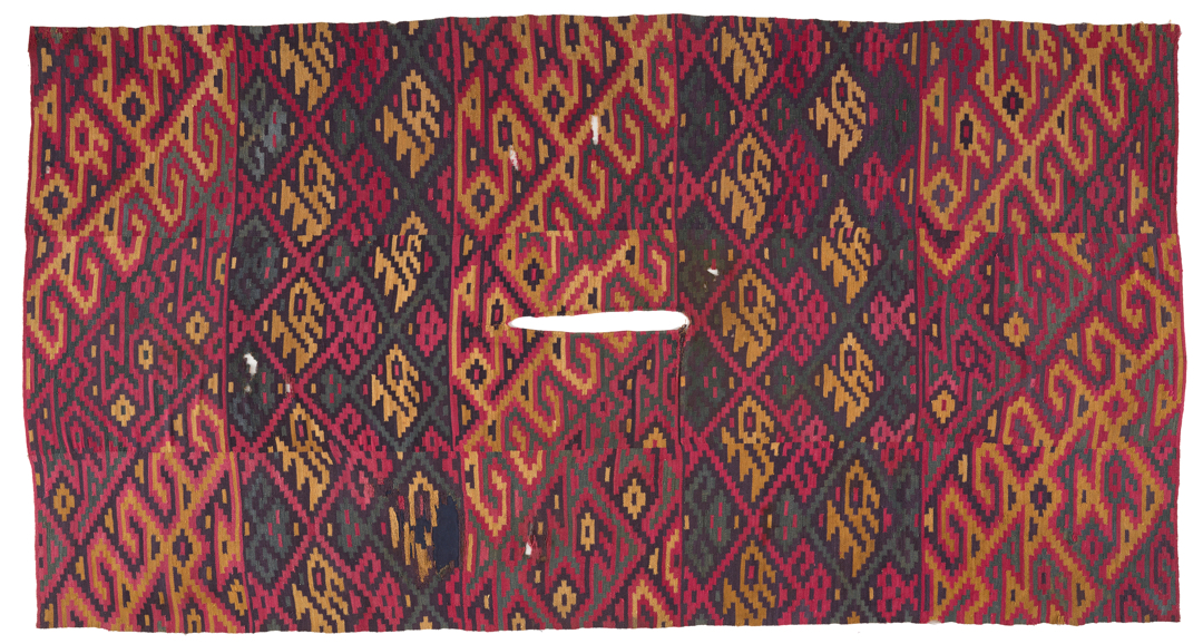 red poncho with bird and geometric designs