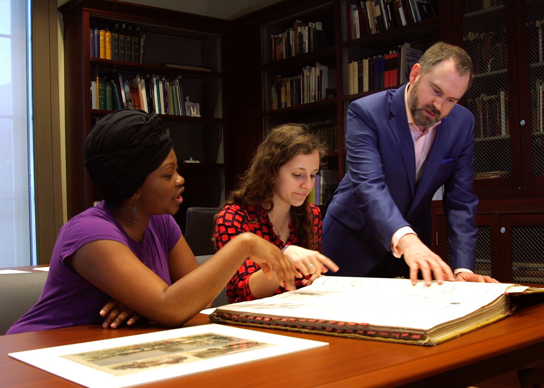 Professor working with two students