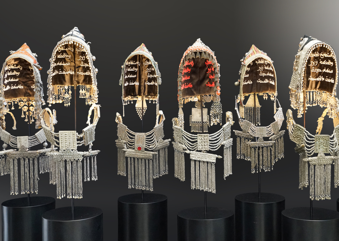 A row of six embellished headdresses