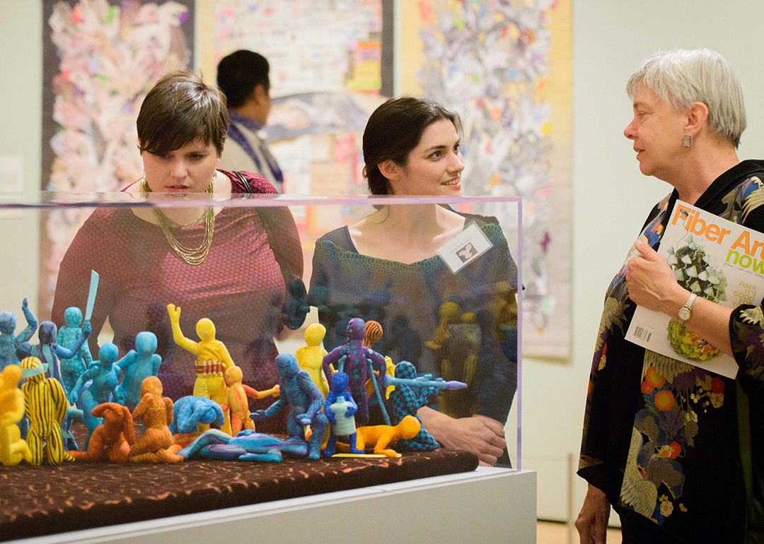 Three visitors in the gallery