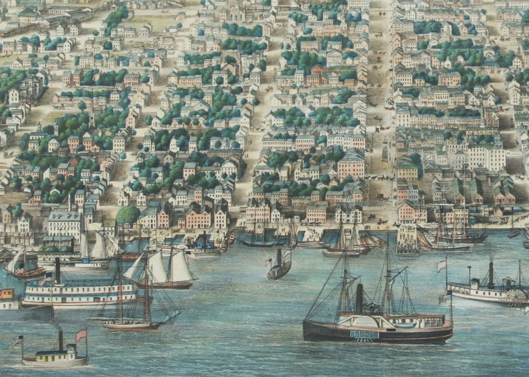 Bird's-eye view print showing boats in a harbor with rows of houses on a hill behind it