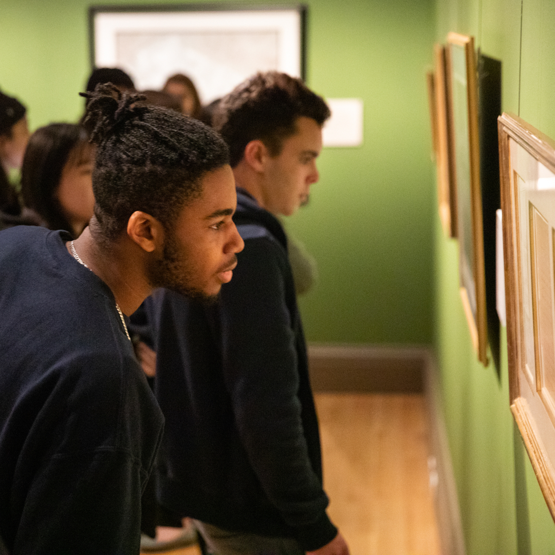 Student looking at art