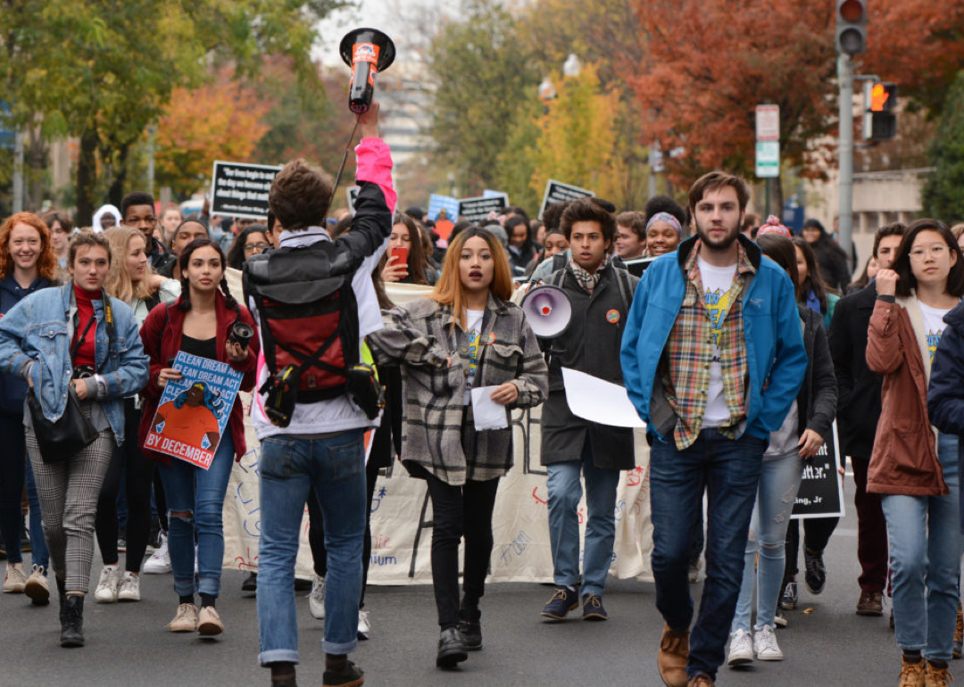 Diverse group of students walking down a street in a protest