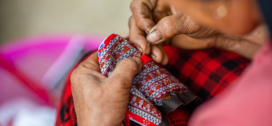 Hands embroidering textile