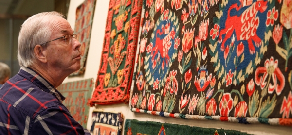 Man looking at Swedish textiles
