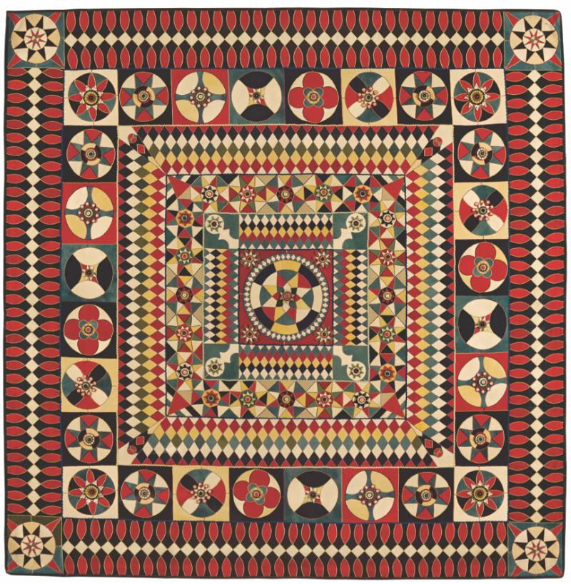 Quilt with geometric patterns in red, yellow, green, black and white