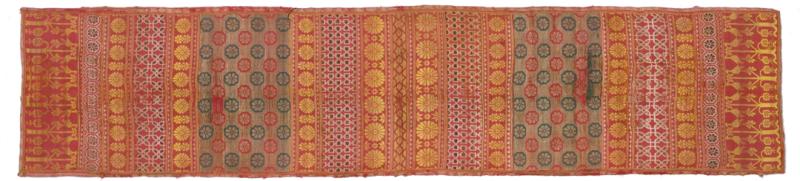 Long red textile with floral and geometric motifs