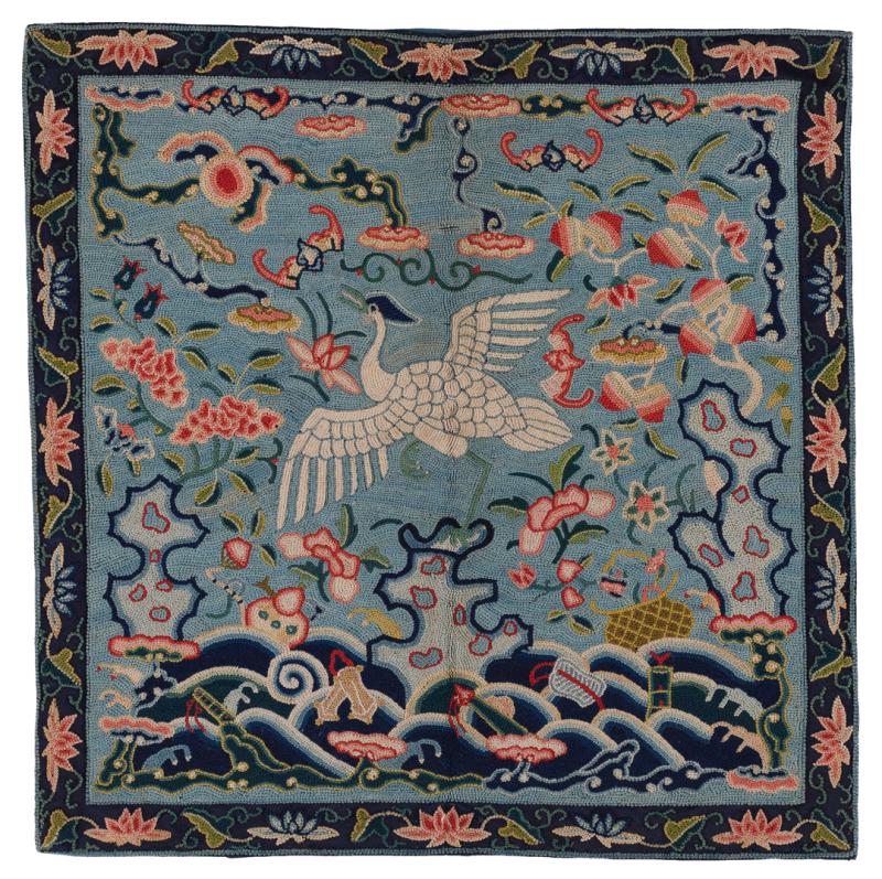 Blue badge depicting a white egret