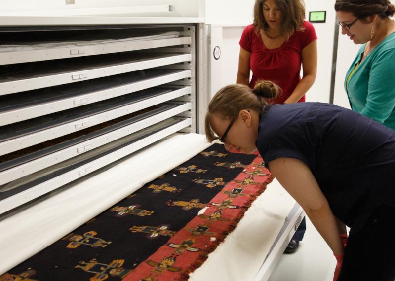woman looking at textile in drawer