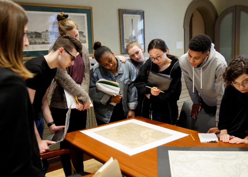 Students looking at a map on a table