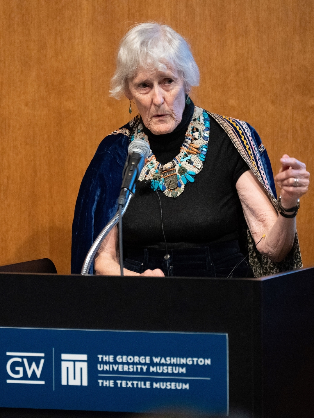 Elizabeth Wayland Barber speaks at a podium