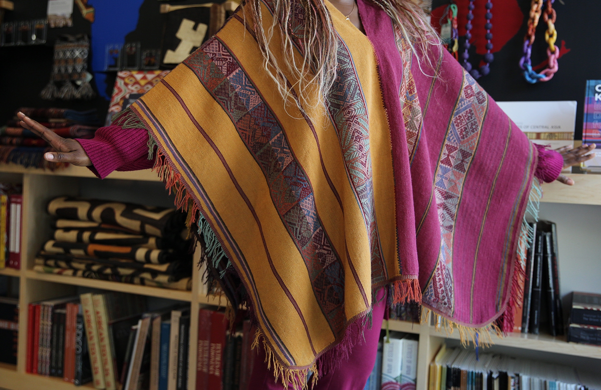 woman wearing a peruvian poncho 