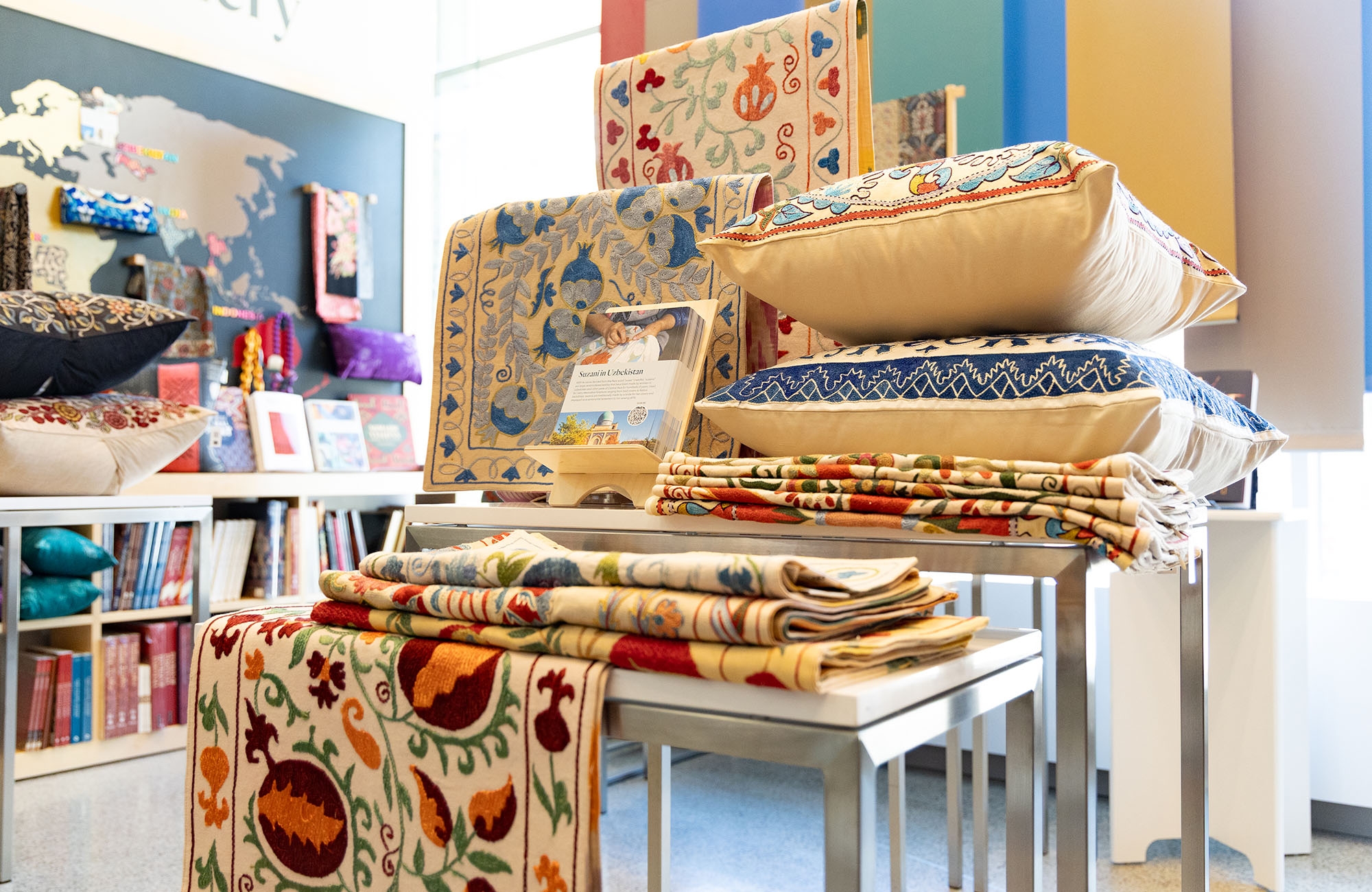 table of colorful embroidered textiles