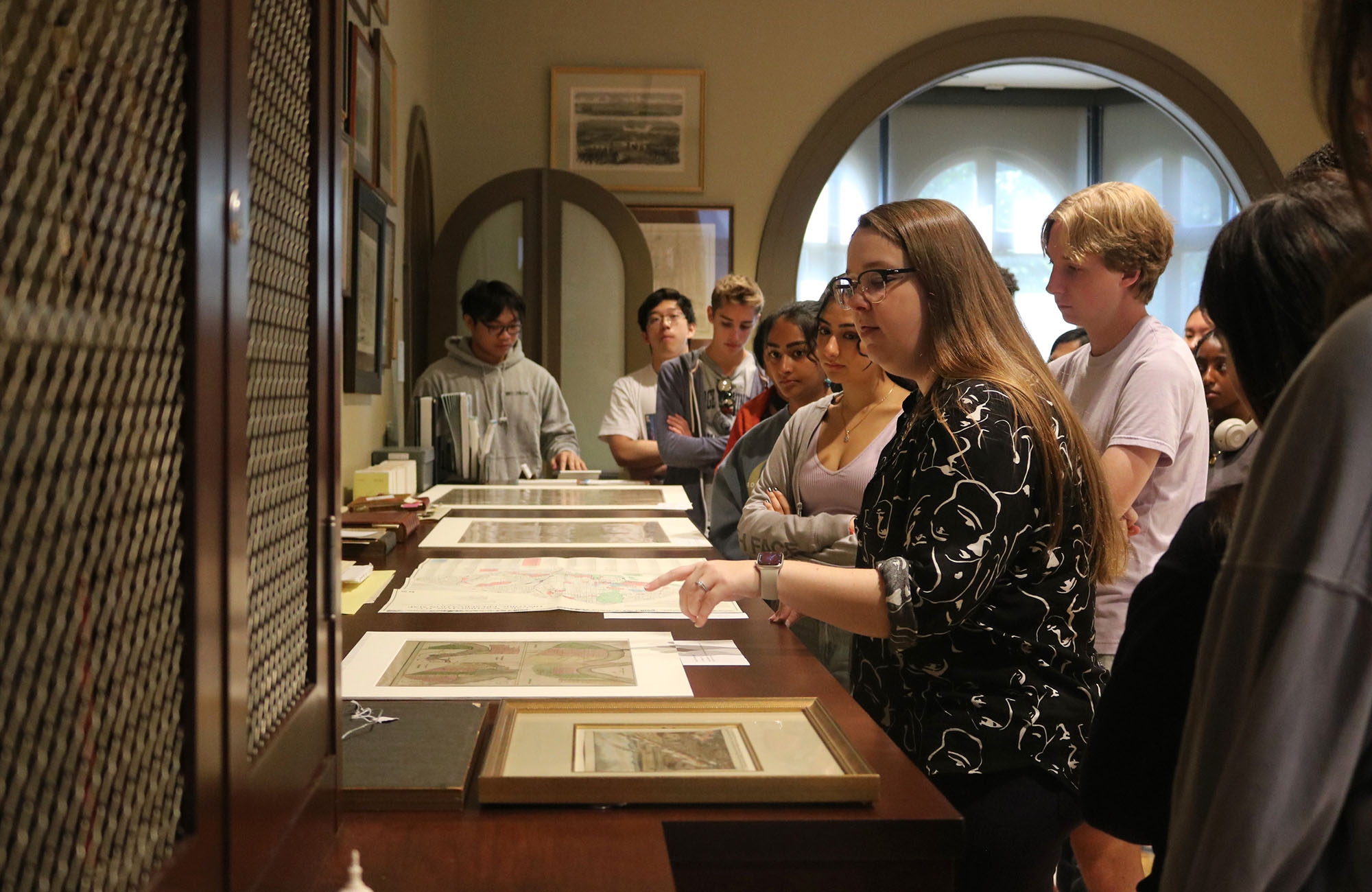 a professor shows a class of college students archival material