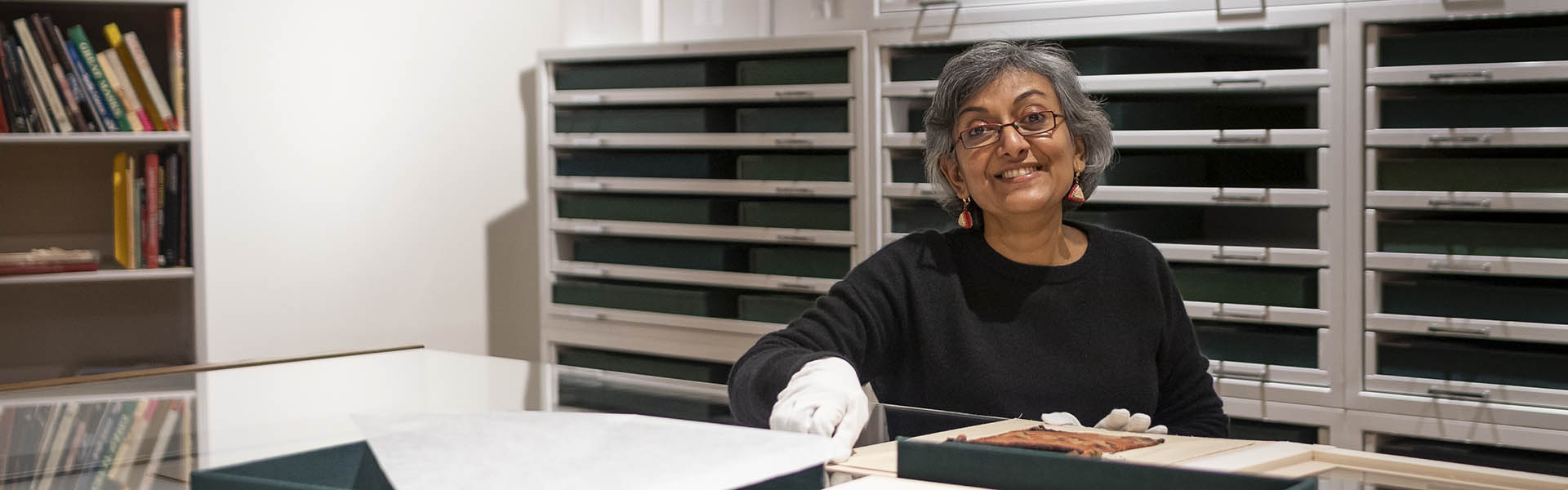 a woman in a study center smiling