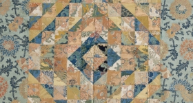 patchwork textile made of gold, blue and teal colored textiles in an expanding diamond pattern